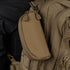 A Condor Sunglasses Case in tan, featuring a zippered design, is attached to a matching Condor tactical backpack—both crafted from durable fabric with multiple compartments and zippers.